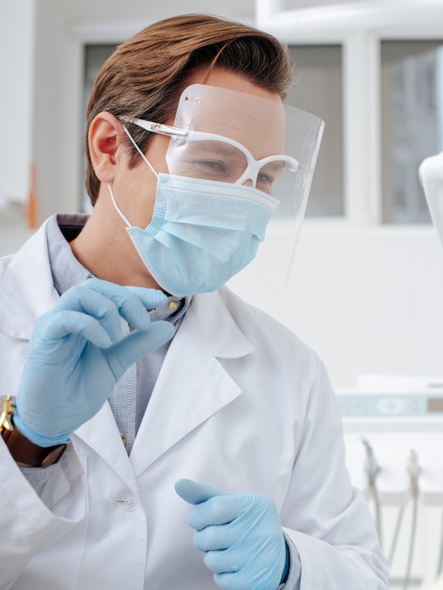 Male pharmacist pointing at prescription information for customer