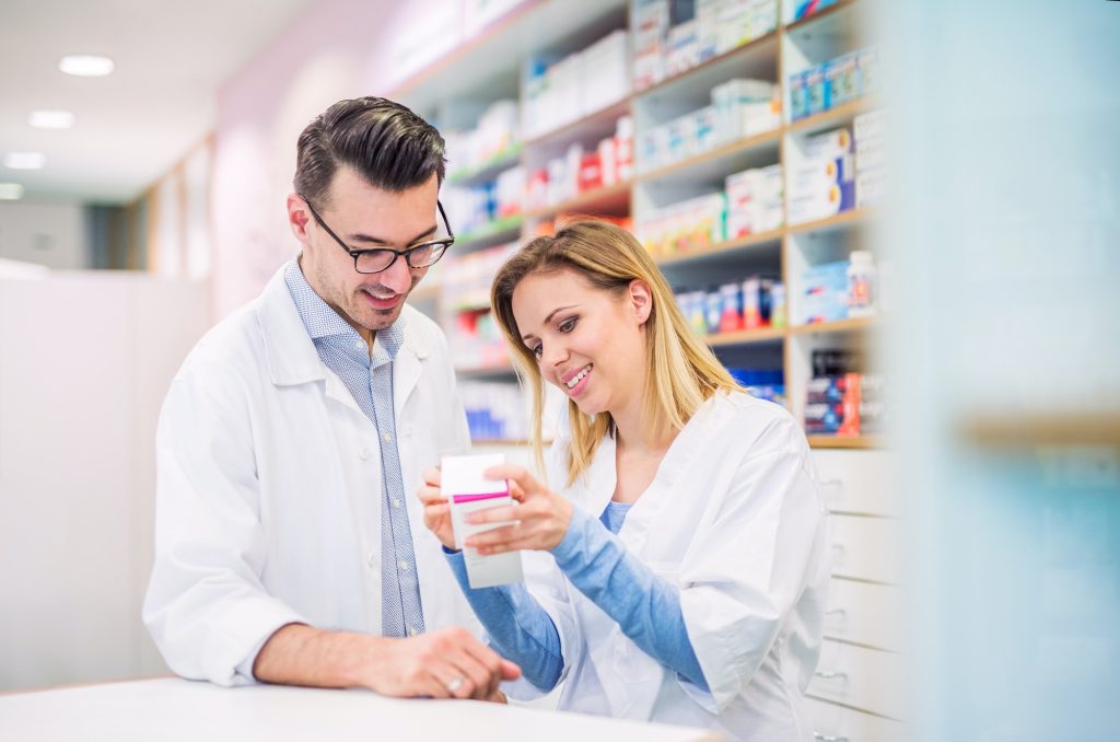 Two pharmacists reviewing prescription – RX services in Brooklyn.