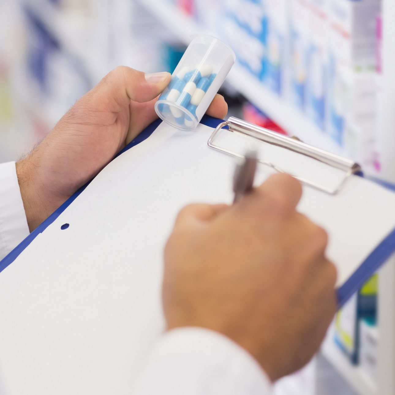 Pharmacist consulting with a client over prescription instructions
